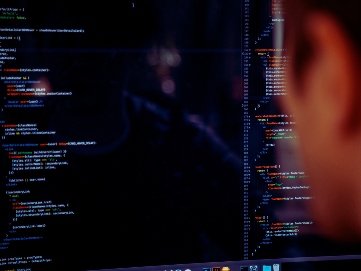 Person viewing computer screen with code displayed