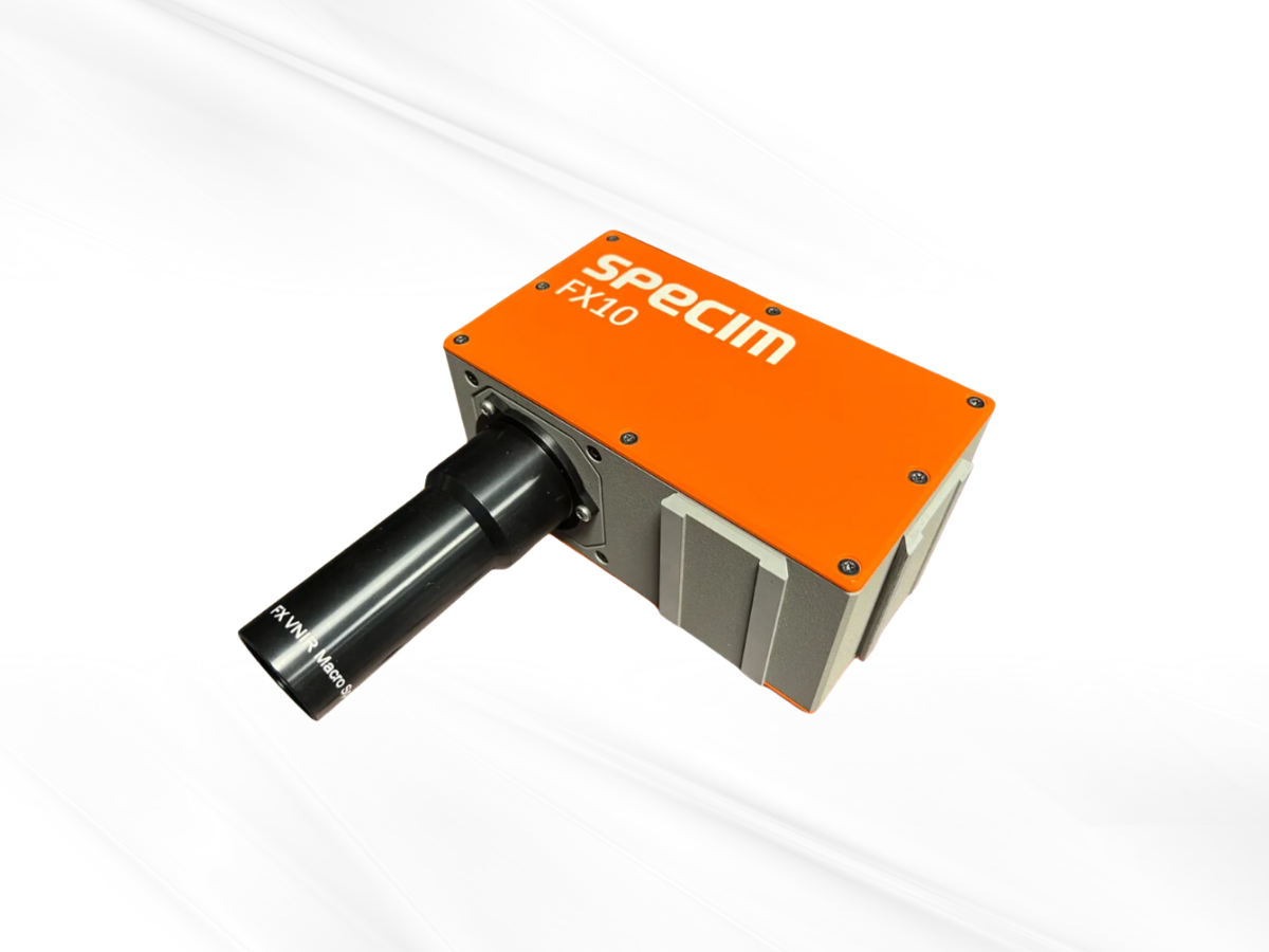 Specim FX10 camera with mounted macro objective lens on white background.