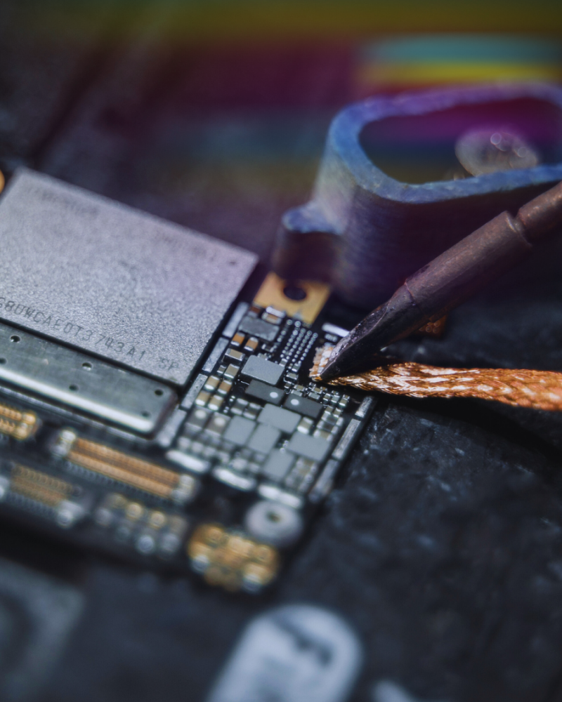 Electronics being soldered onto a motherboard