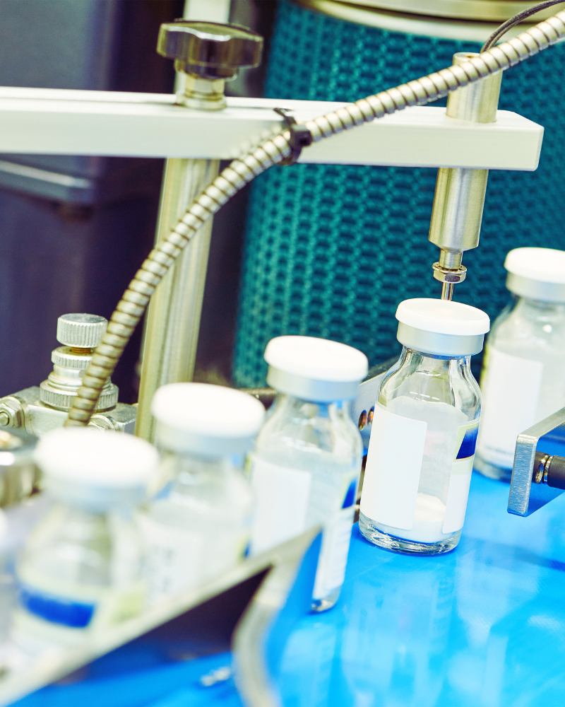 Production line filling bottles with medication