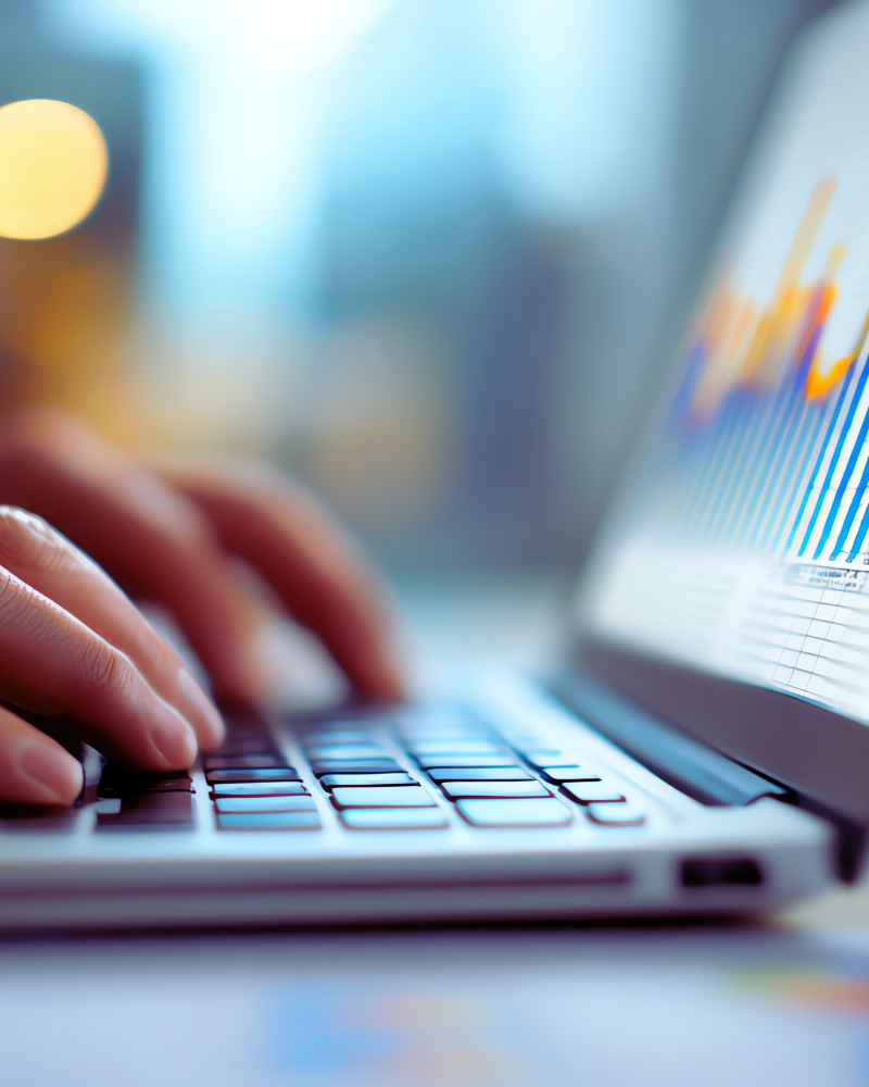 Close-up image of person typing on a laptop
