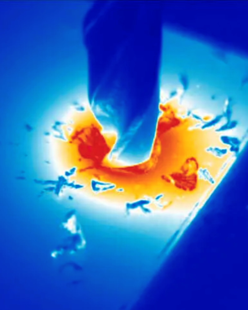 Thermography image of drill bit drilling into surface showing heat map