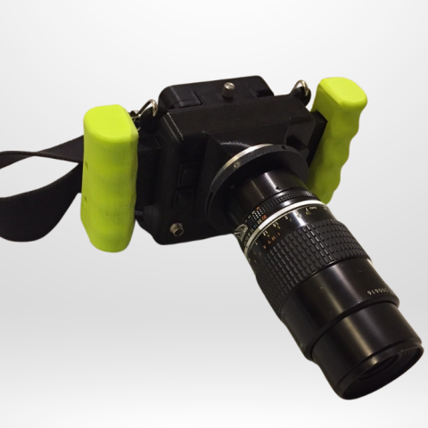CRIS II cerenkov viewing device with black body, mounted nikon lens, green ergonomic handles and neck strap.